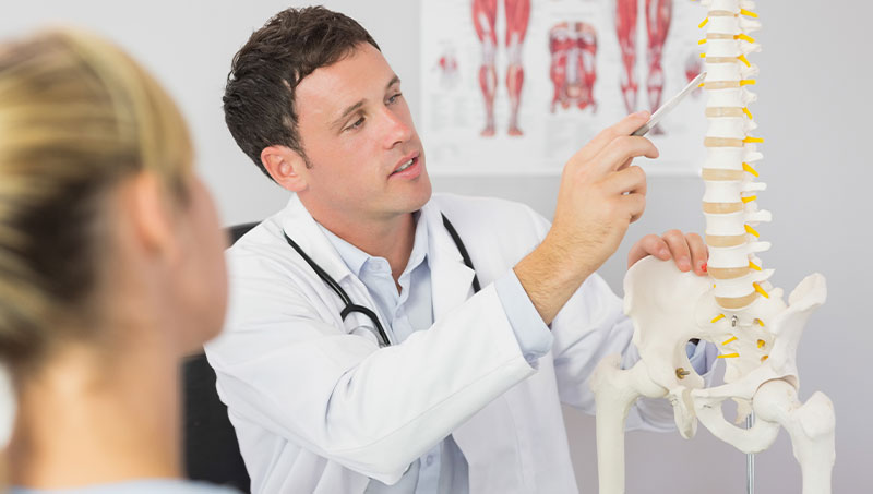 Chiropractor explaining spine health to patient